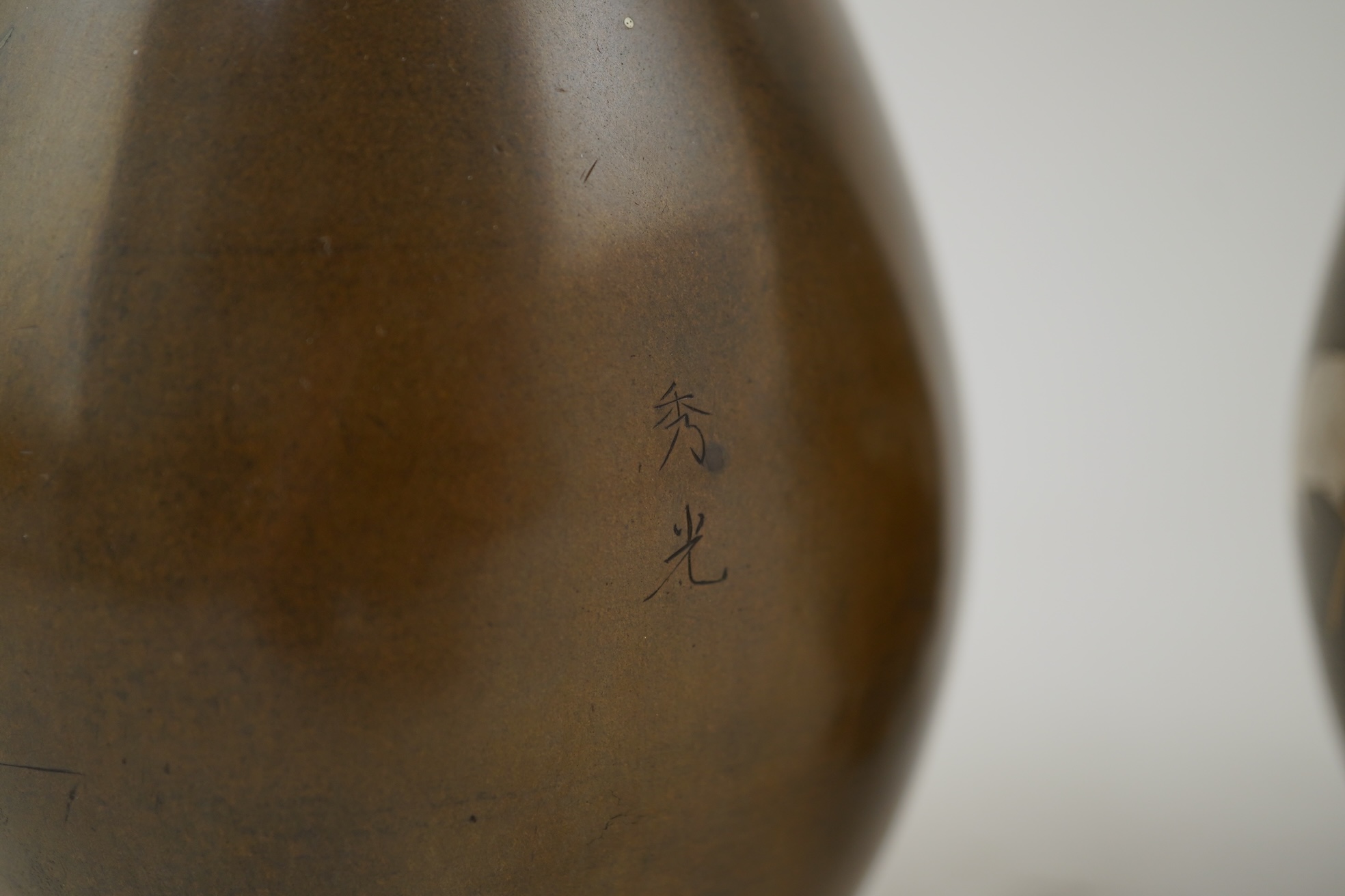 A pair of Japanese bronze and mixed metal inlaid bottle vases, signed Hidemitsu, Meiji period